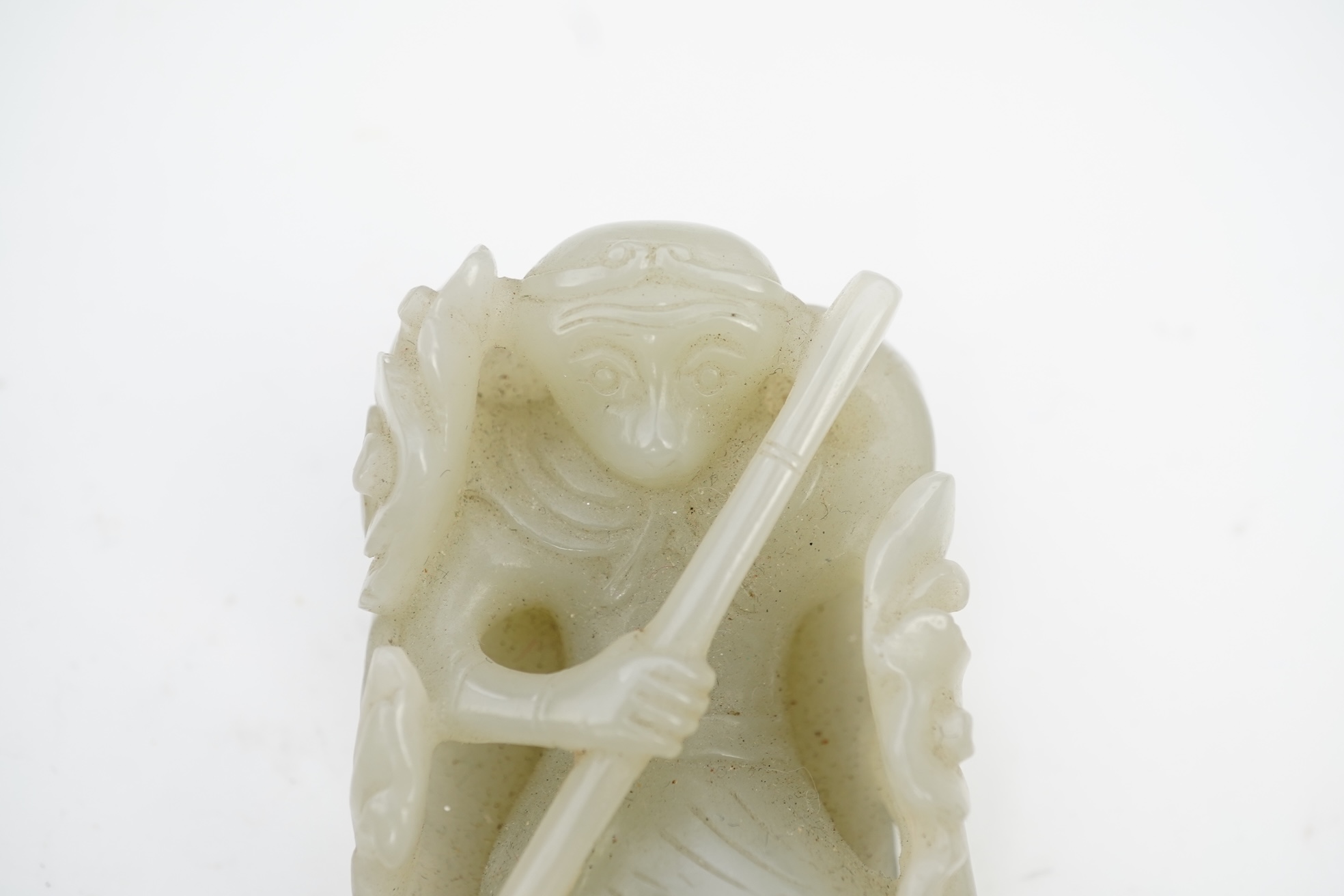 A Chinese pale celadon jade carving of Sun Wukong, the Monkey King, 18th/19th century